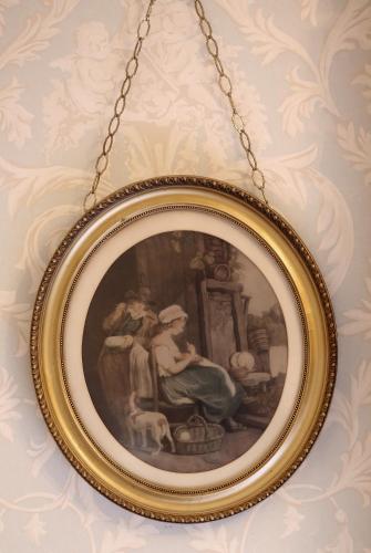 a picture frame hanging on a wall with a chain at Llangattock Park House in Crickhowell