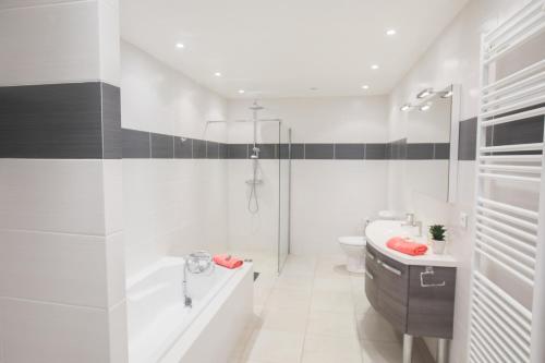 a white bathroom with a sink and a toilet at Vinaigrier Hills VI3086 by Riviera Holiday Homes in Nice