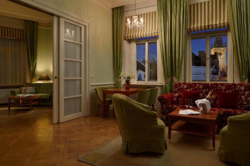 a living room with a couch and a table at Ventana Hotel Prague in Prague