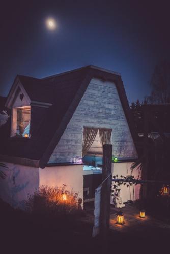 a house with lights in the window at night at Holiday Home Wonderland with private Spa/Wellness in Ralingen