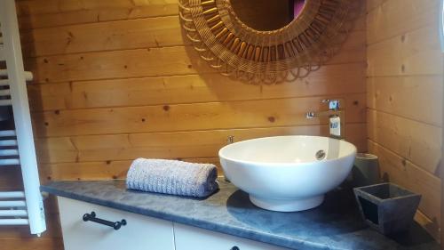 a bathroom with a white sink and a mirror at Chalet Les Lilas in Colmar