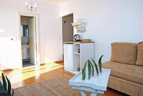 a living room with a couch and a table at Hotel Delfin in Zadar