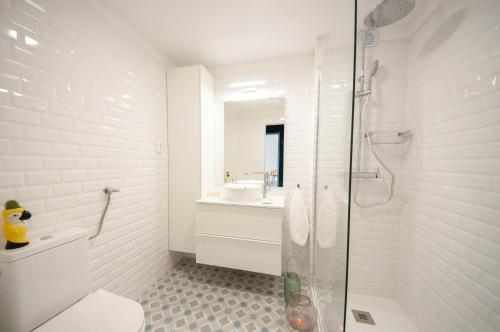a bathroom with a shower and a toilet and a sink at Algarve Beaches Apartment by Portugal Collection in Porches
