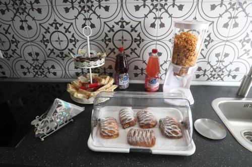 a table with a tray of donuts on a counter at La casa di Luce in Reggio Calabria