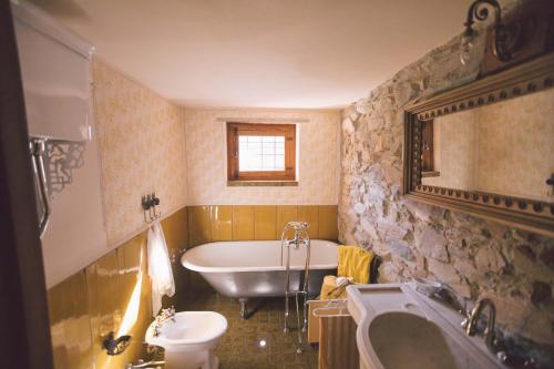 a bathroom with a bath tub and a sink at Mulìn Turcìn in Coassolo Torinese
