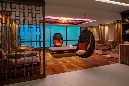 a living room with a couch and a swing at Silver Legacy Reno Resort Casino at THE ROW in Reno