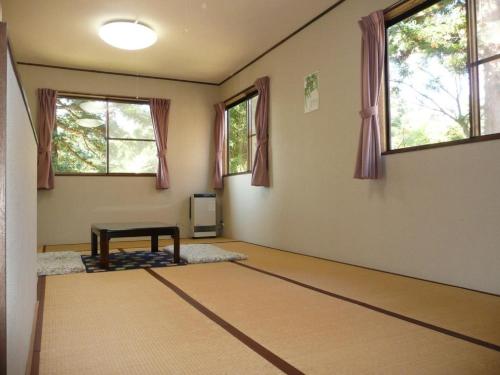 an empty room with a table in a room with windows at Myoko - Hotel / Vacation STAY 24124 in Myoko