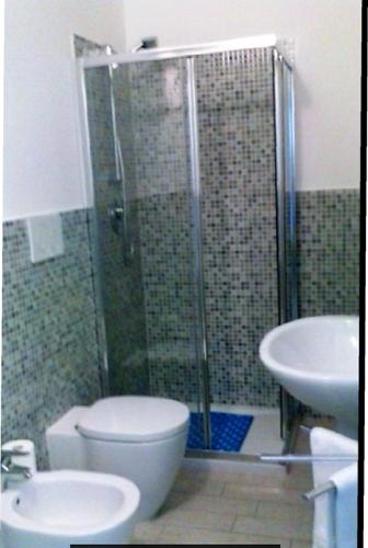 a bathroom with a shower and a toilet and a sink at La bella vista in Castelsardo