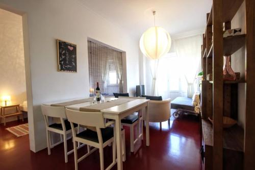 a kitchen and dining room with a table and chairs at Belém Calling Apartment in Lisbon