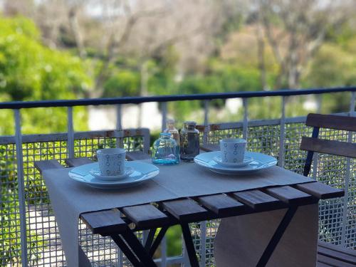 a wooden table with two cups and drinks on it at Belém Calling Apartment in Lisbon