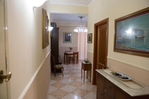 a hallway with a room with a sink and a table at BUTTERFLY in Castellammare di Stabia