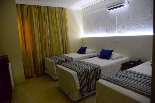 Una cama o camas en una habitación de JVA Fenix Hotel