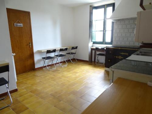 a kitchen with two tables and chairs in a room at Albergue Convento Del Camino in Tui