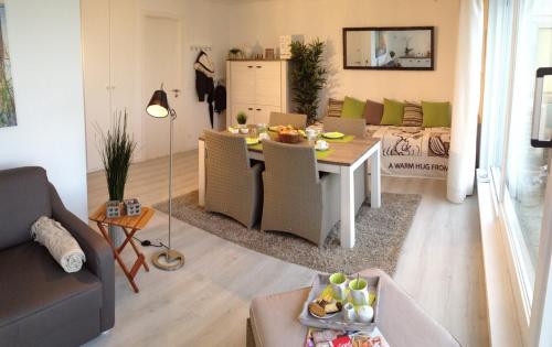 a living room with a table and a couch at Penthouse SEAFLOWER in Blankenberge