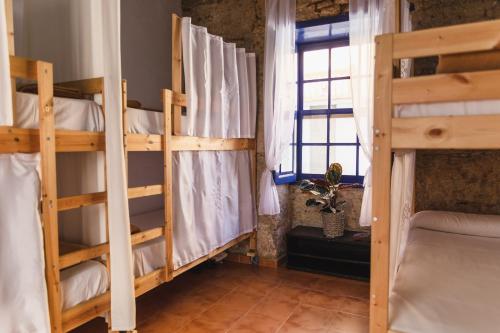a room with two bunk beds and a window at Ashavana Hostel in El Médano