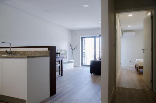 a room with a kitchen and a living room at Central Inn in Ponte de Lima