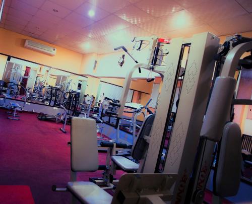 a gym with a bunch of machines in it at Hotel 71 in Dhaka