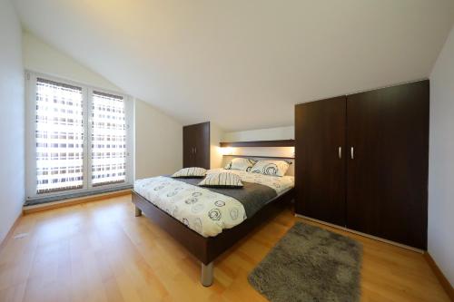 a bedroom with a large bed and a large window at Luxury Villa Nada with Pool in Petrcane