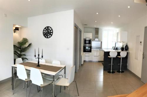 une salle à manger et une cuisine avec une table et des chaises dans l'établissement Appart T4 Christina contemporain, Vue Lac, climatisé avec parking, à Aix-les-Bains