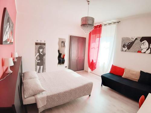 a bedroom with a bed and a couch in it at B&B Margot in Trento
