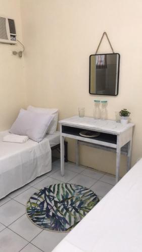 a room with two beds and a table with a tv at Ignacio’s Place in Bacolod
