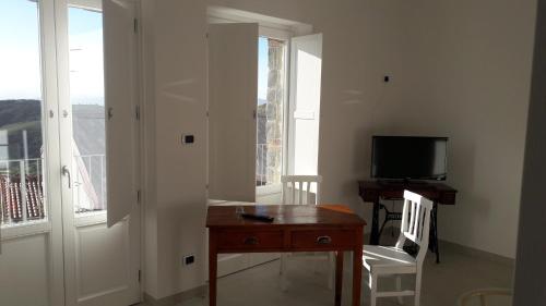 a room with a desk and a tv and a window at La Casa dei Panorami di Colobraro in Colobraro