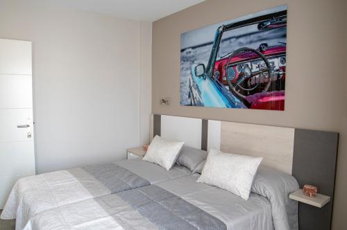 a bedroom with a bed with a tv on the wall at Alojamiento Turistico La Casa del tio Cesar in Cañas