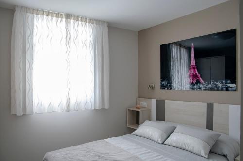 a bedroom with a bed with a tv on the wall at Alojamiento Turistico La Casa del tio Cesar in Cañas
