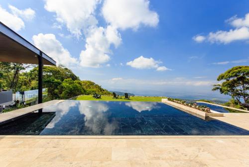 a swimming pool in the middle of a house at Rancho Pacifico - Boutique Hotel for Adults in Uvita