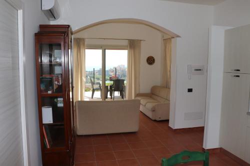 a living room with a couch and a table at Casa con vista panoramica in Sciacca