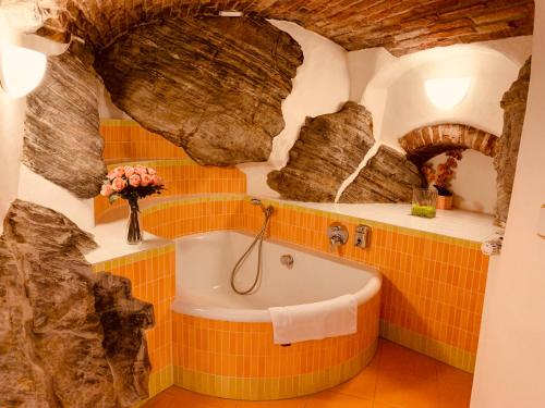 a bathroom with a bath tub in a cave at Penzion Kapr in Český Krumlov