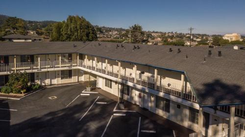 an apartment building with a parking lot and a balcony at Inn By the Bay Monterey in Monterey