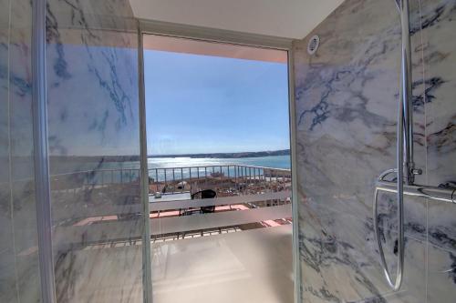 a bathroom with a shower with a view of the ocean at Solar Dos Mouros in Lisbon