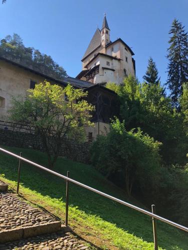 a building with a tower on top of a hill at DAD HOME in Cles