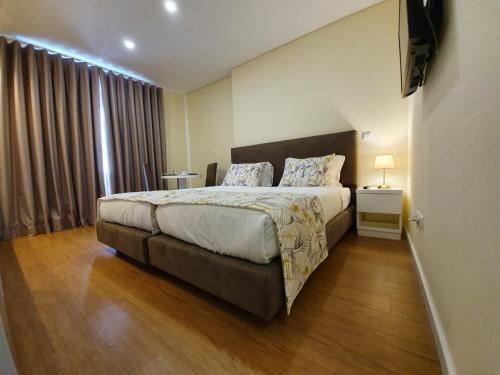 Säng eller sängar i ett rum på Agnelo Comfort - Accommodation H V