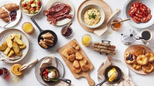 a white table with plates of food on it at The Star Grand Hotel and Residences Sydney in Sydney