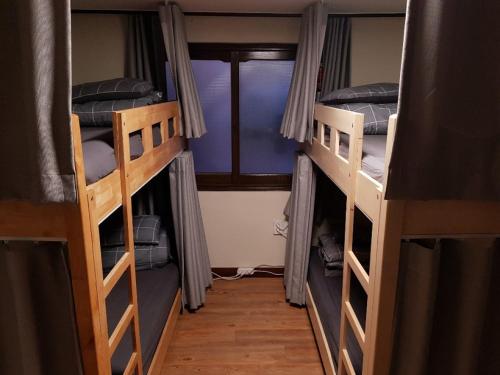 a room with three bunk beds in a room at Able Guesthouse Hongdae 2 in Seoul