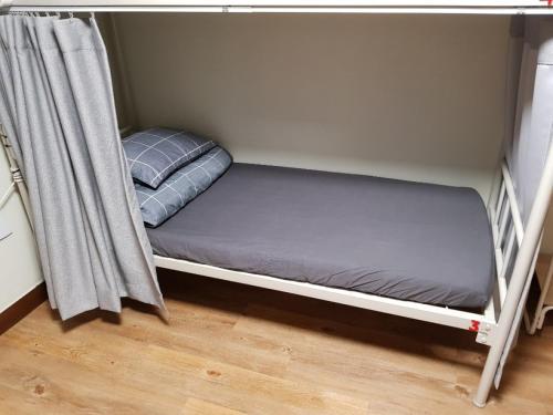 a bunk bed in a room with a mattress at Able Guesthouse Hongdae 2 in Seoul