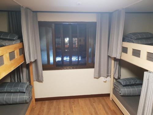 a room with two bunk beds and a window at Able Guesthouse Hongdae 2 in Seoul