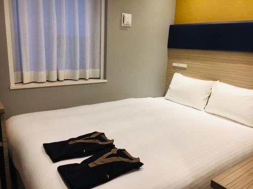 Postel nebo postele na pokoji v ubytování Hotel WBF Grande Hakata