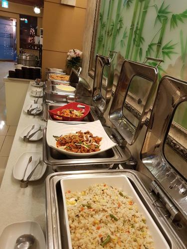 a buffet line with many plates of food at Amour Hotel in Suwon
