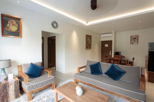 a living room with two couches and a table at Cove Resort Palau in Koror