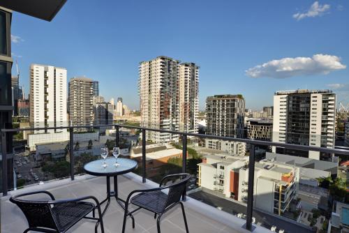 a restaurant with a balcony overlooking a city at Brisbane One Apartments in Brisbane