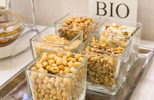 a bunch of different types of food in glass containers at Best Western Plus Royal Superga Hotel in Cuneo