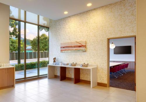 a living room with a table and a tv at Hyatt House Portland / Downtown in Portland