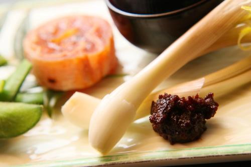 a plate of food with chopsticks and some vegetables at Nobori in Ome