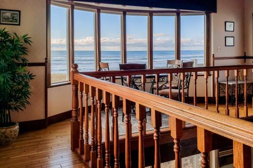 a staircase in a house with a view of the ocean at Expansive Views Family Oceanfront Beach Home in Westport