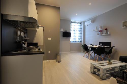 eine Küche und ein Wohnzimmer mit einem Tisch und Stühlen in der Unterkunft Apartments Karla in Rijeka