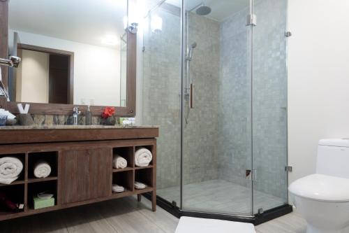 a bathroom with a shower and a sink at Cove Resort Palau in Koror