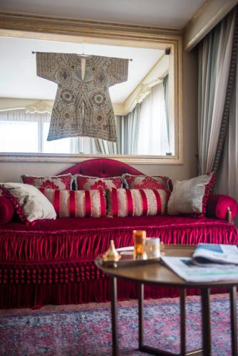 a red couch in a living room with a table at Romance Istanbul Hotel Boutique Class in Istanbul